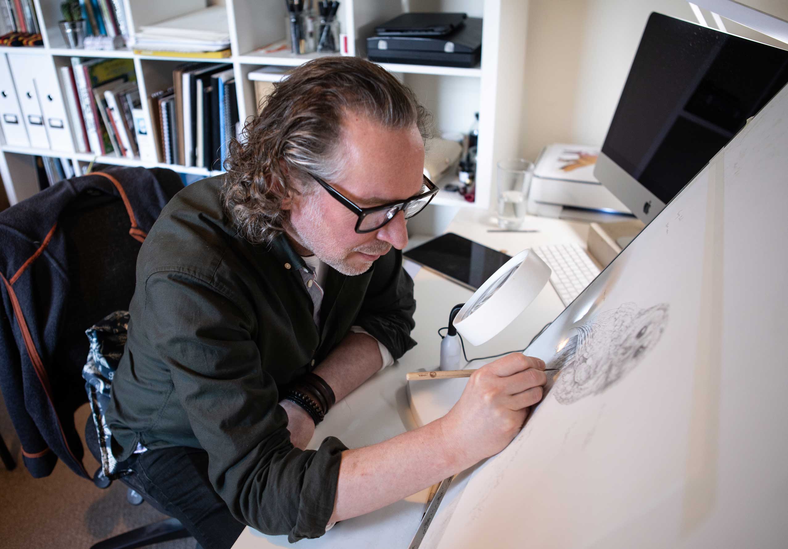 Photo of Nick Ellwood illustrator drawing an owl. Credit Charlie Fox.