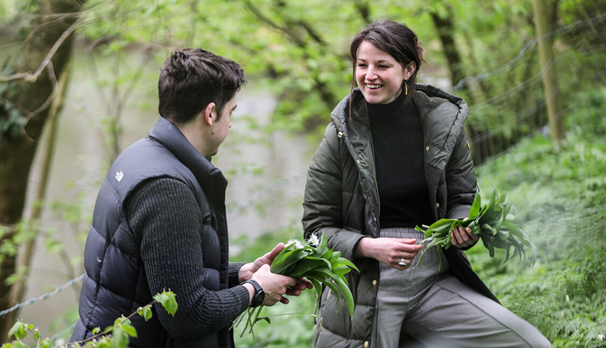 A couple foraging in woodland