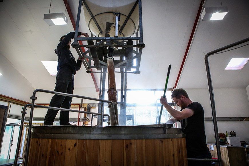 Man stirring inside vat, another stood on top by Ceri Oakes Man stirring inside vat, another stood on top by Ceri Oakes
