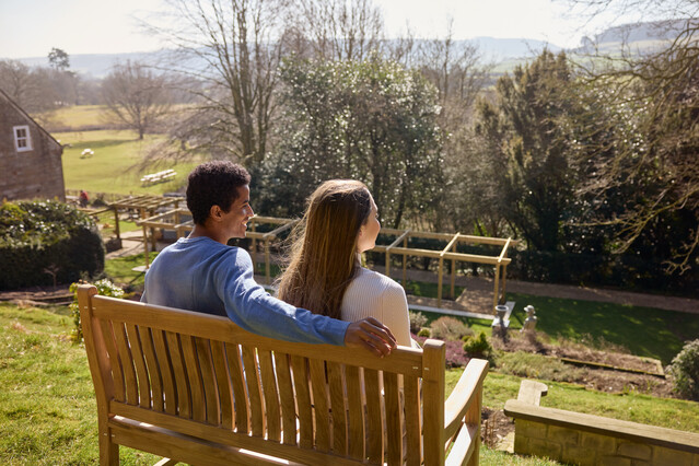 Couple sent on a bench looking outwards
