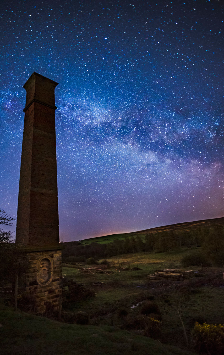 Old industrial tower with a starry sky overhead.