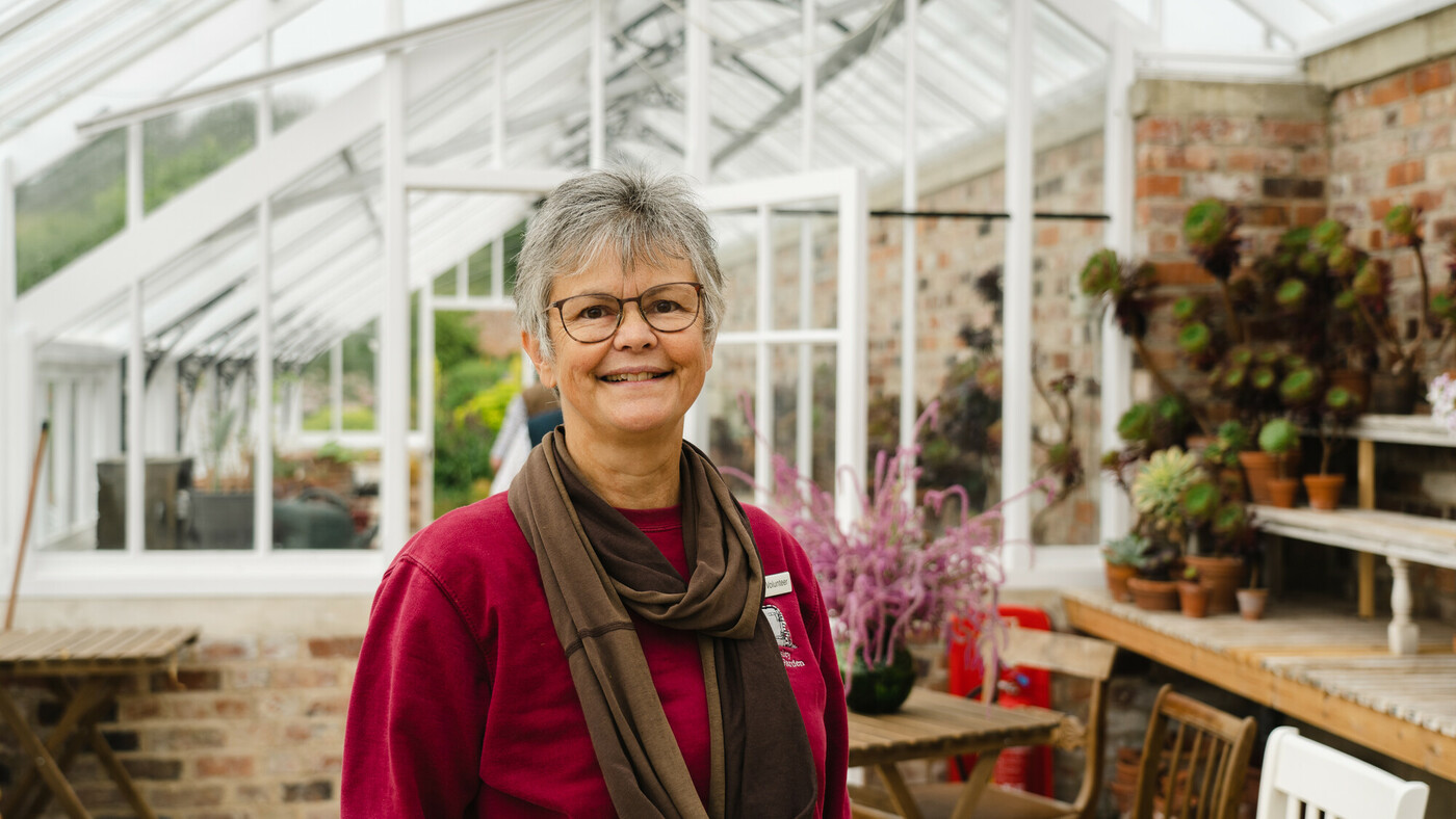 Woman standing inside a newly restored wooden and brick greenhouse. Credit Anglo American. Woman standing inside a newly restored wooden and brick greenhouse. Credit Anglo American.
