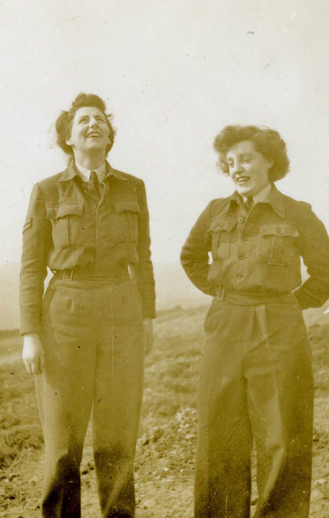 Black and white photograph of two women stood side-by-side.
