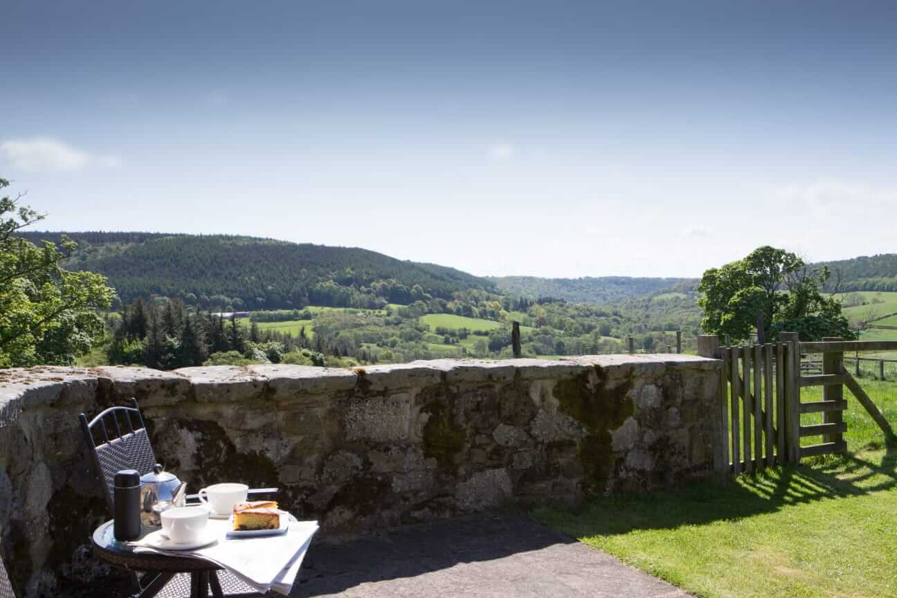 Tea for two set up on a chair with vast views of the North York Moors in the background