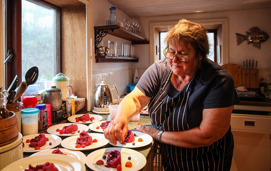 Lisa serving up plates of dessert by Ceri Oakes