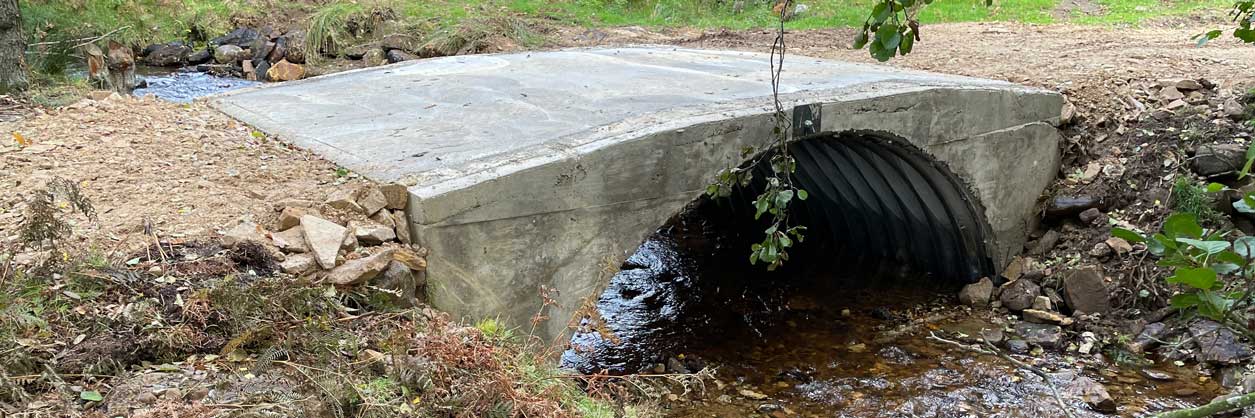 A newly created small farm access bridge over a river