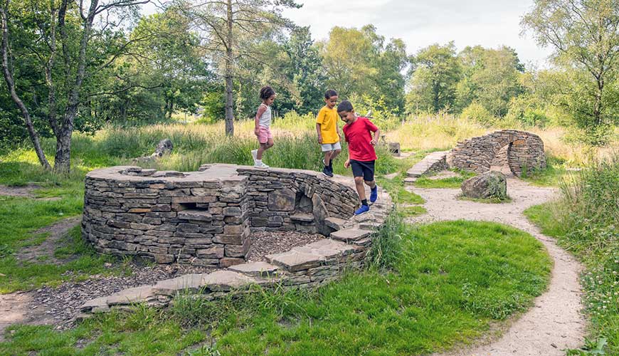 Children playing on stone sculpture