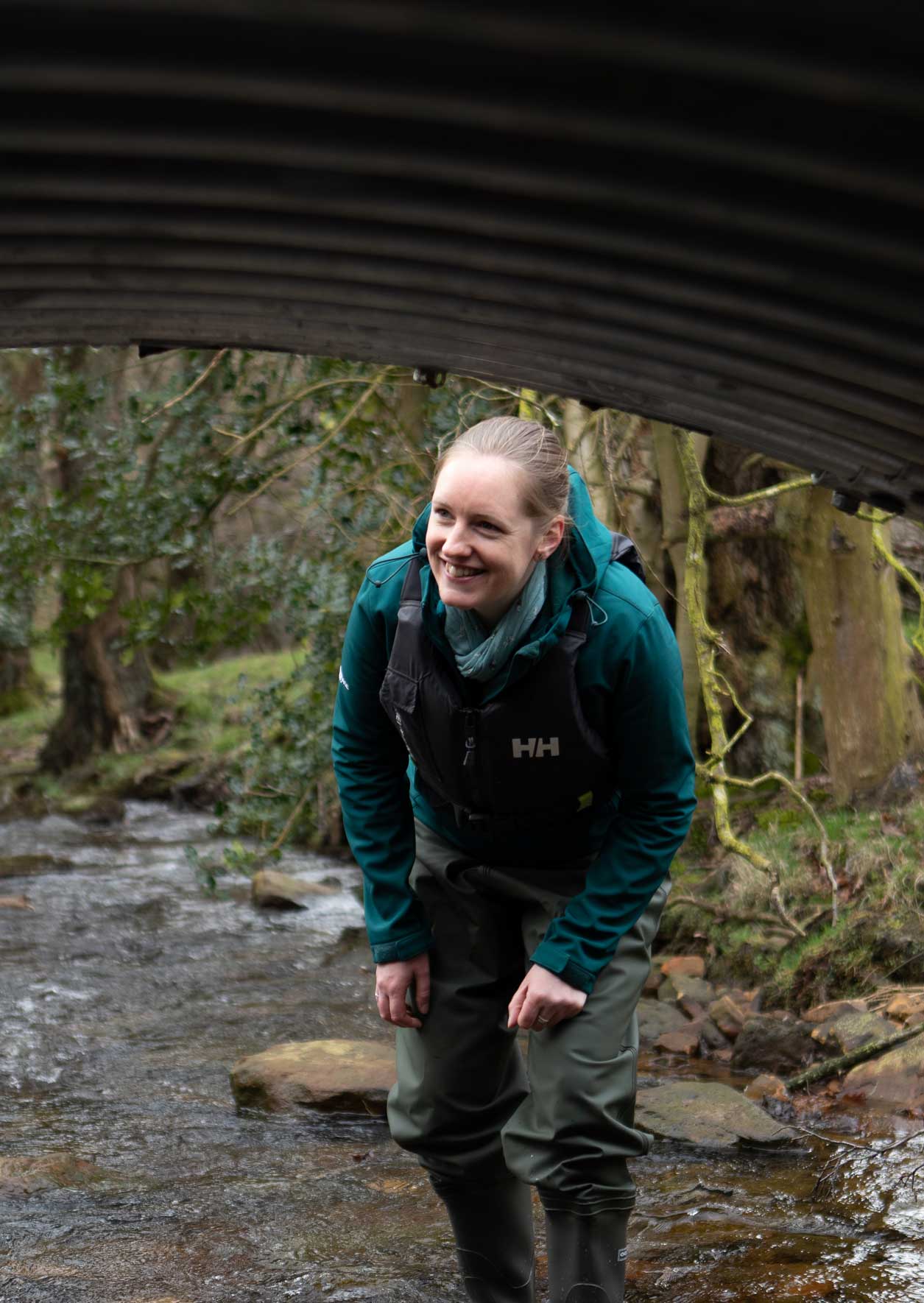 Female looking at a newly constructed small bridge over a river. Credit Charlie Fox.