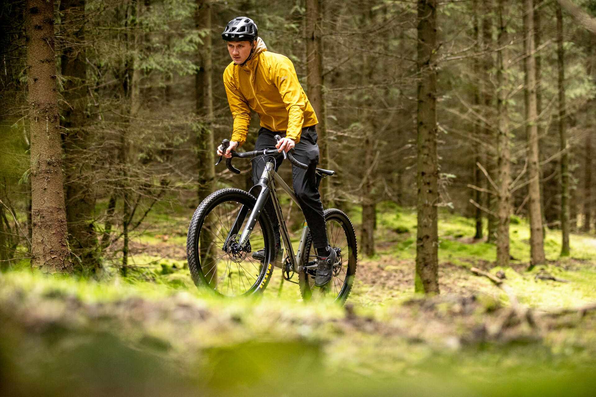 Gravel bike rider cycling through forest canopy credit Mick Kirkman