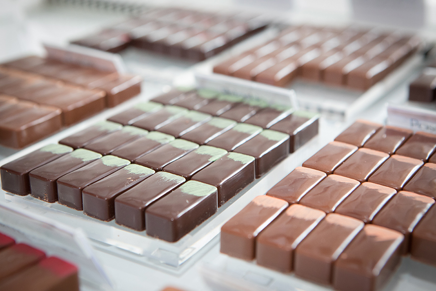 Chocolates displayed on counter by Polly Baldwin Chocolates displayed on counter by Polly Baldwin