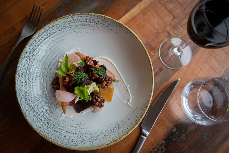 Roast beetroot salad served on a plate with glass of red wine beside by Polly Baldwin Roast beetroot salad served on a plate with glass of red wine beside by Polly Baldwin
