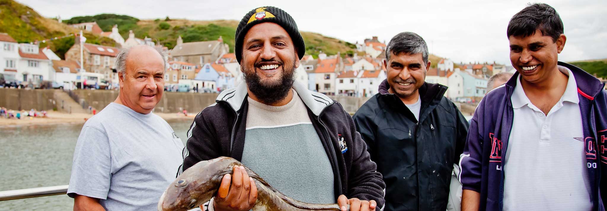 Four people celebrating after catching a large fish. Credit Chris J Parker_NYMNP.