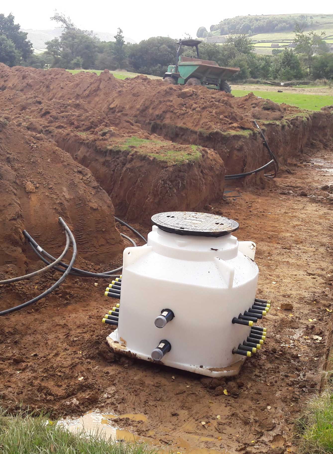New excavated trenches in a field for ground sourced heat pumps.