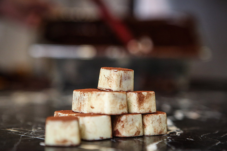 A close up of white chocolate stacked as a pyramid by Ceri Oakes A close up of white chocolate stacked as a pyramid by Ceri Oakes