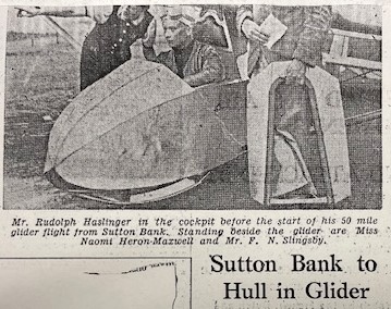Rudolph Haslinger newspaper clipping from the archive of the Yorkshire Gliding Club Newspaper clipping showing a black and white photo of Mr. Rudolph Haslinger seated in a glider cockpit, with two individuals standing nearby. Text announces a 50-mile flight.
