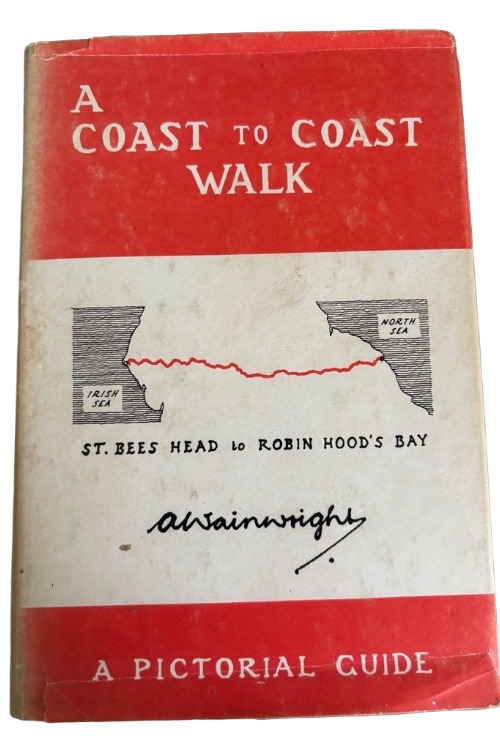Cover of "A Coast to Coast Walk" by A. Wainwright. Features an orange and white design, a map illustration of the route, and bold, clear text.