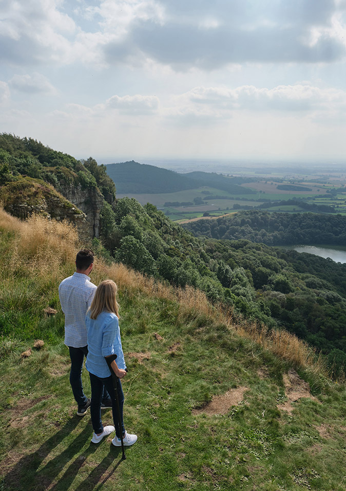 Couple walking at Sutton Bank, woman is using a walking stick (c) VisitBritainDaniel Wildey