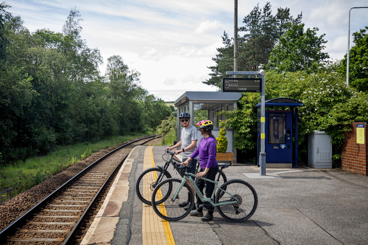 Cyclist waiting for train at Castleton station credit Mick Kirkman