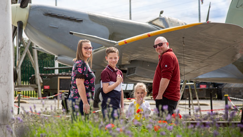 Family next to Second World War fighter aircraft