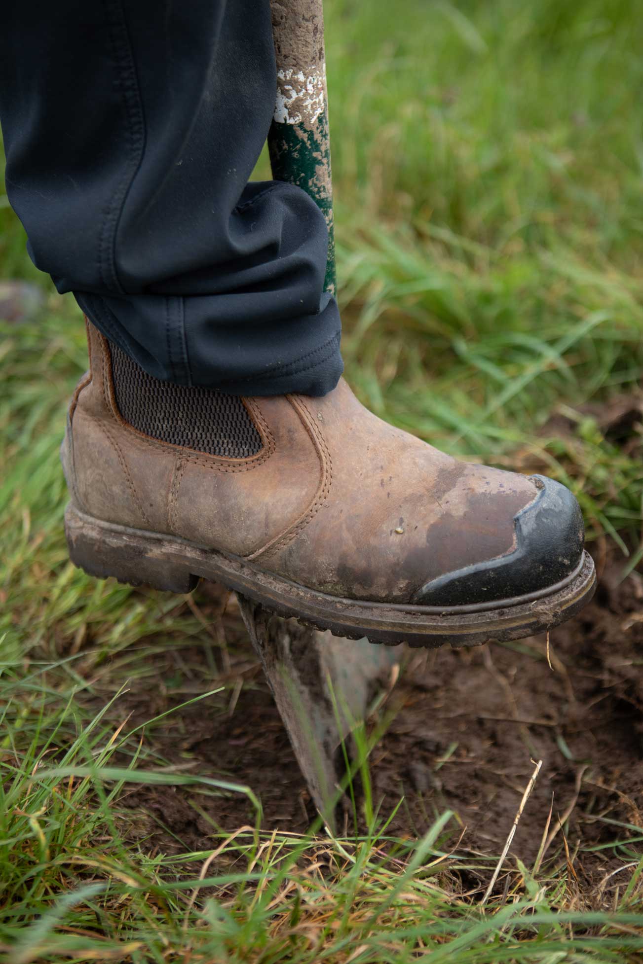 Close up of a foot pushing a spade into the ground. Credit Charlie Fox.