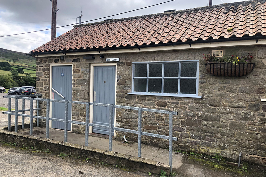 Accessible toilet at Low Mill car park showing ramp to entrance Accessible toilet at Low Mill car park showing ramp to entrance