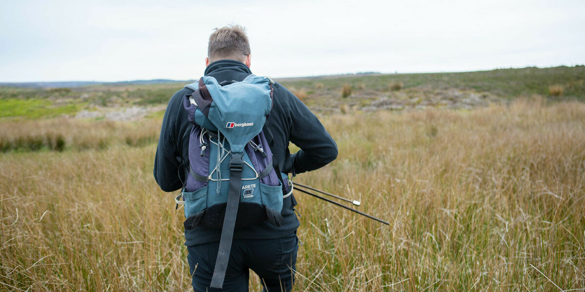 Ed March-Shawcross walking into a moorland landscape. Credit Charlie Fox