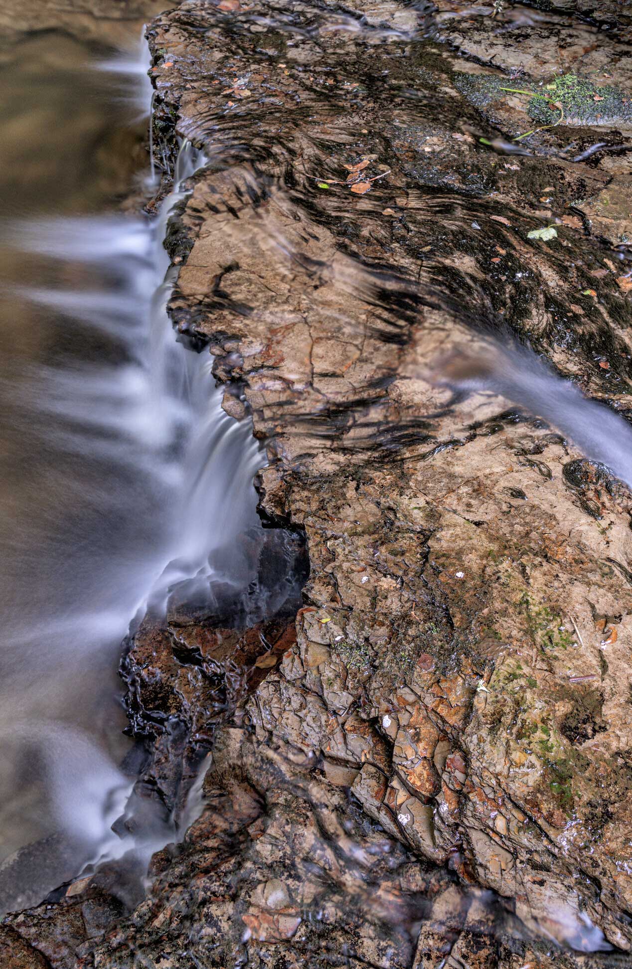 Close up of a river flowing over a rocky surface. Credit Lizzie Shepherd.