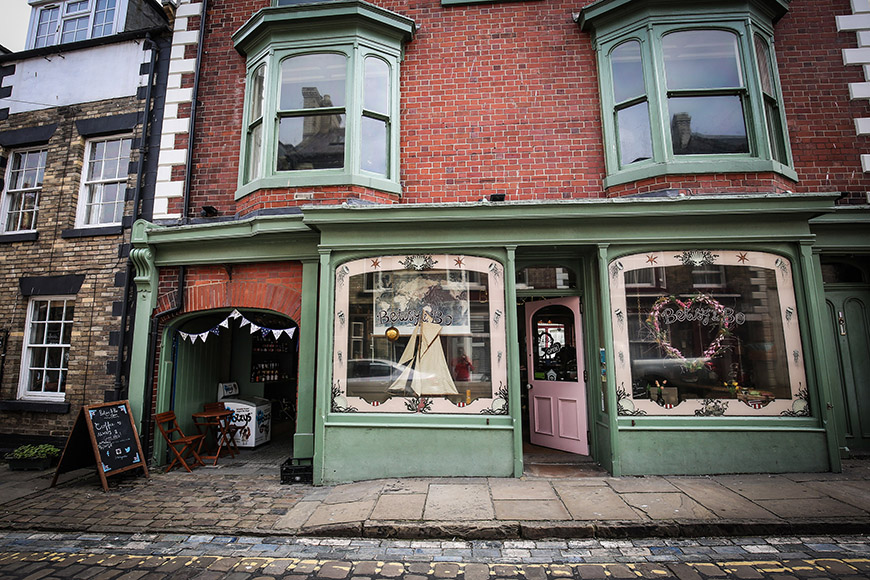 Shop exterior - two large window fronts and alley way to the left by Ceri Oakes Shop exterior - two large window fronts and alley way to the left by Ceri Oakes