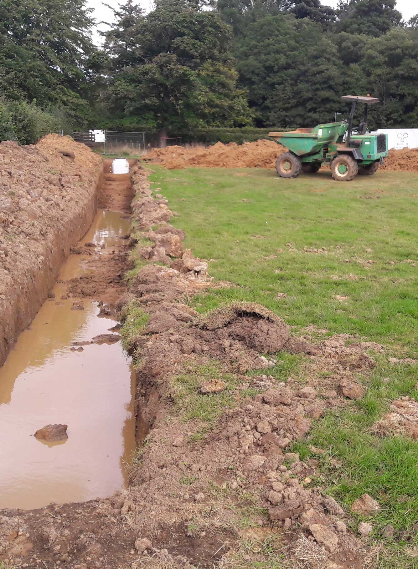 New excavated trenches in a field for ground sourced heat pumps. New excavated trenches in a field for ground sourced heat pumps.