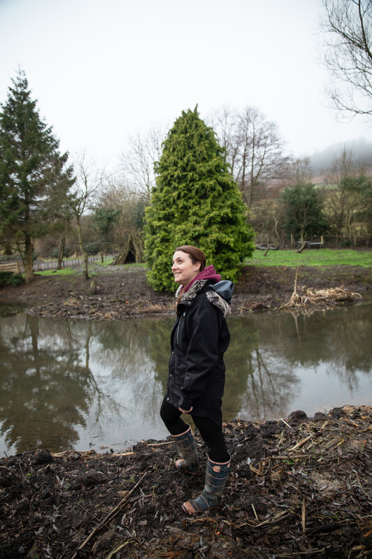 Person looking at a newly created pond. Credit Charlie Fox.