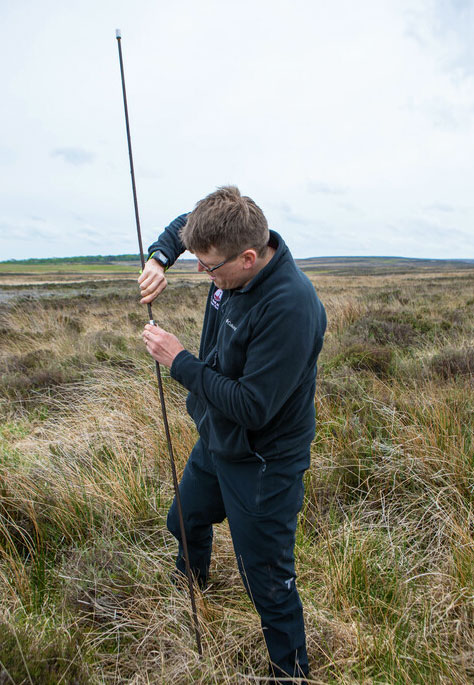 Ed March-Shawcross carrying out a peatland survey on moorland. Credit Charlie Fox