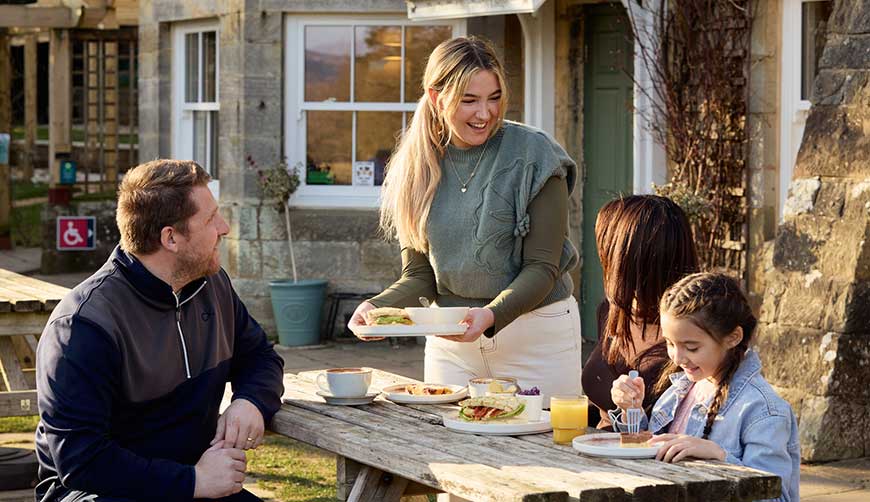 Family enjoying a meal at Danby Lodge