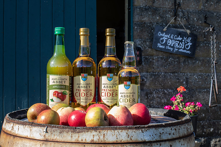 Ampleforth apple juice, cider and apples on a wooden barrel