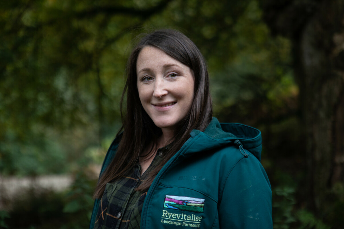 Conservation officer Holly Ramsden. Portrait among woodland. Credit Charlie Fox.