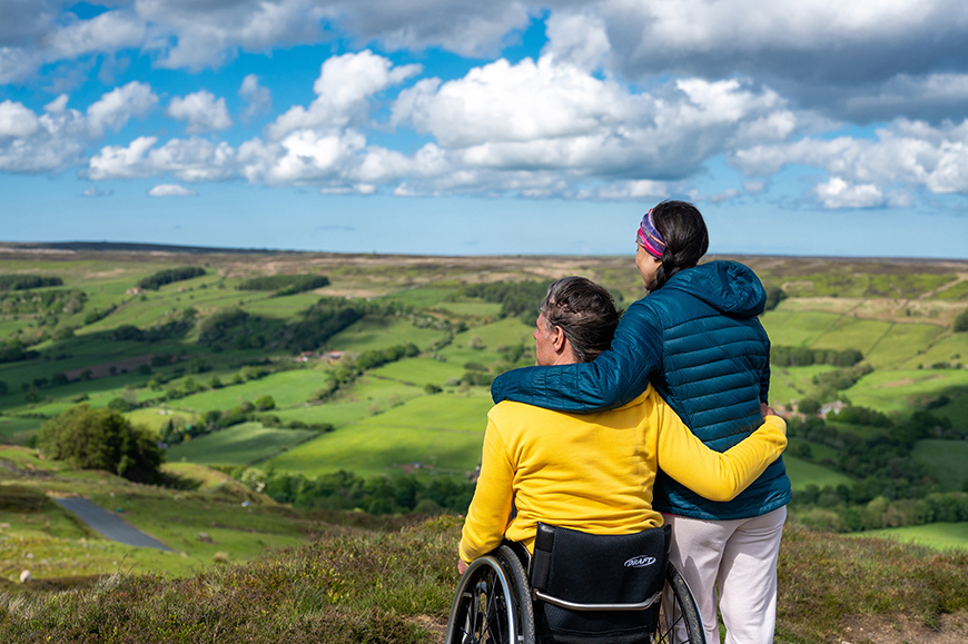 Man and woman at Bank Top, Rosedale, man using a wheelchair Credit VisitBritain/Peter Kindersley