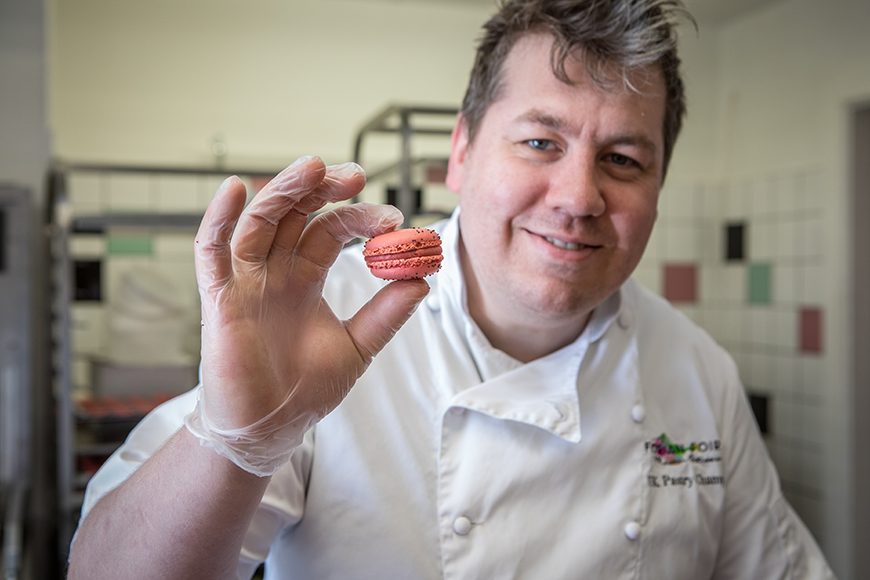 Florian holding up a complete macaron by Polly Baldwin
