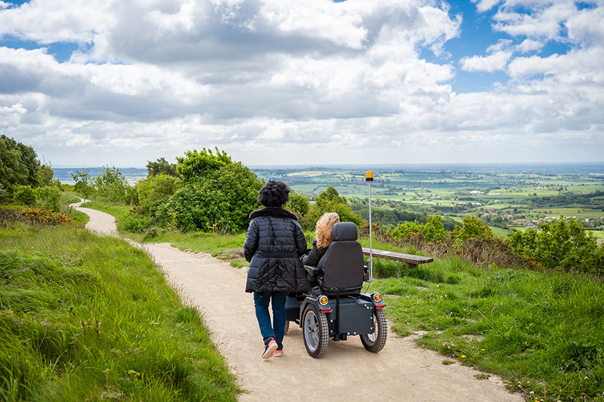 Two women on the White Horse Trail, one using a tramper