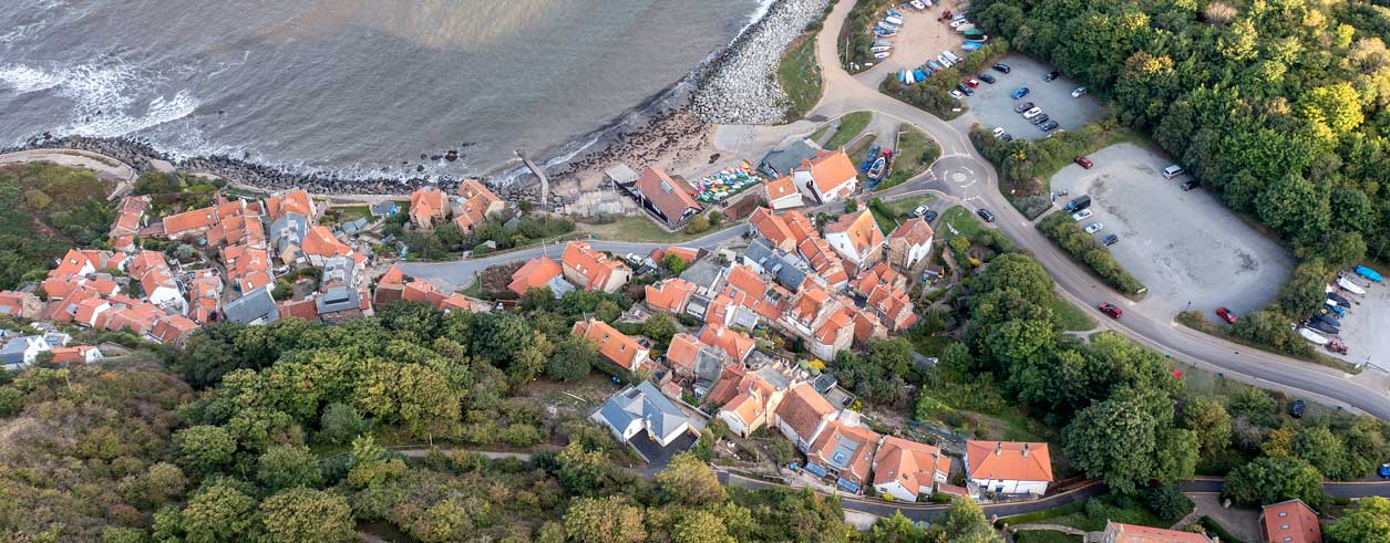 Drone photo looking down on coastal village. Credit Paul Kent.