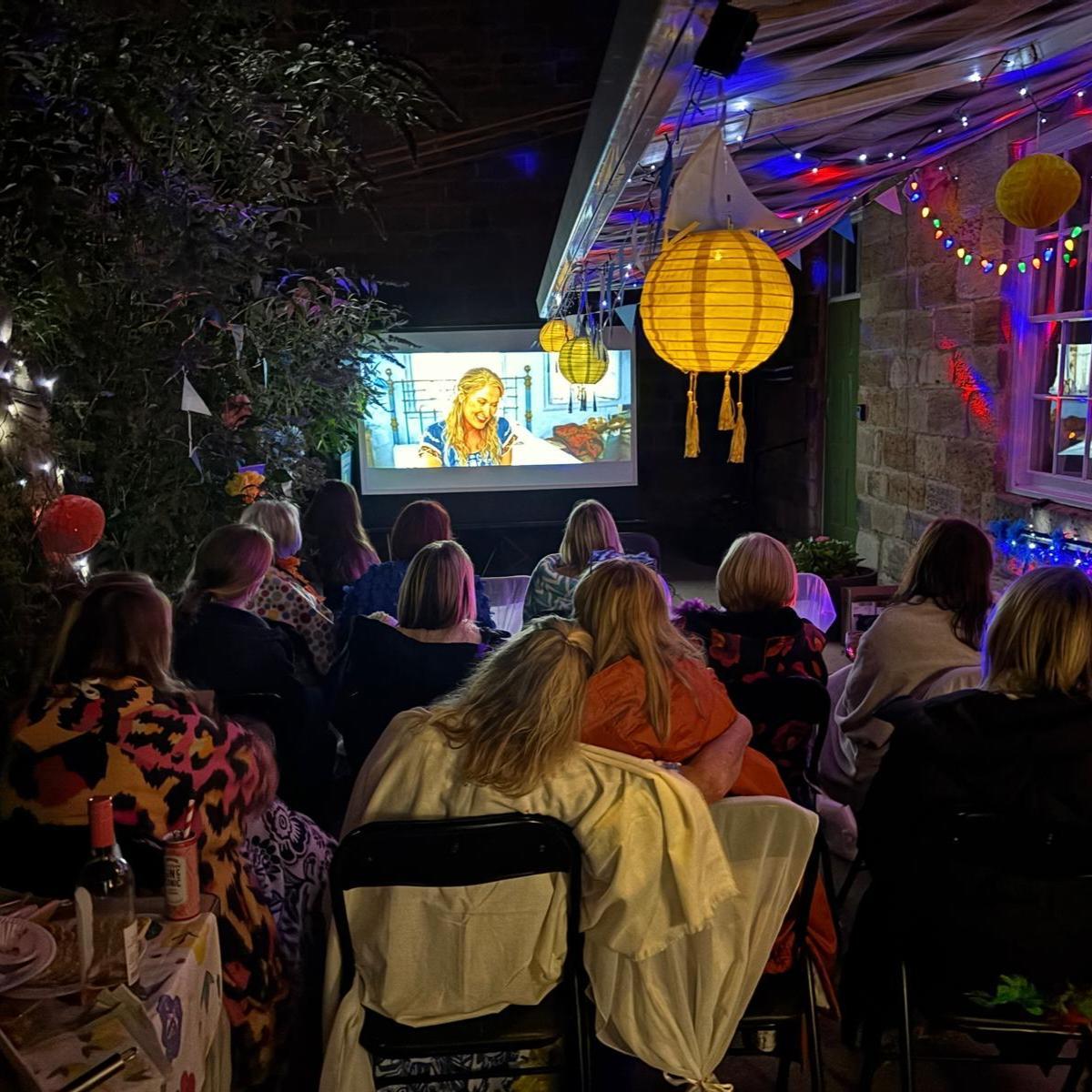 A crowd watching a film