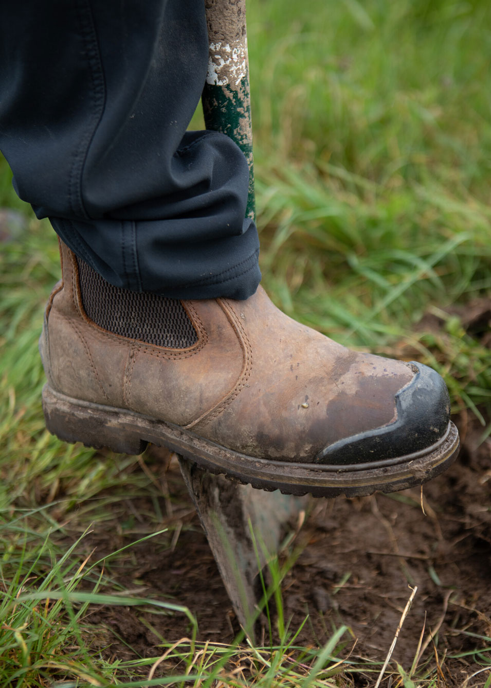 Close up of boot pressing a spade into the soil. Credit Charlie Fox.