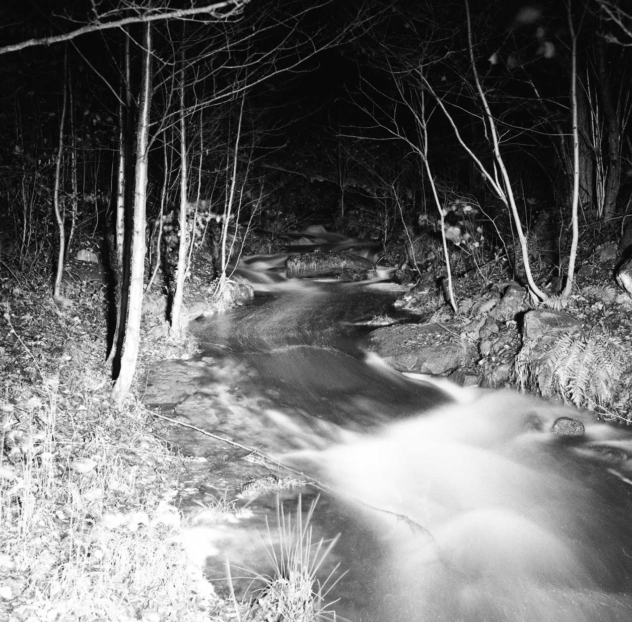 Nighttime - a black and white photograph of river by John Arnison.