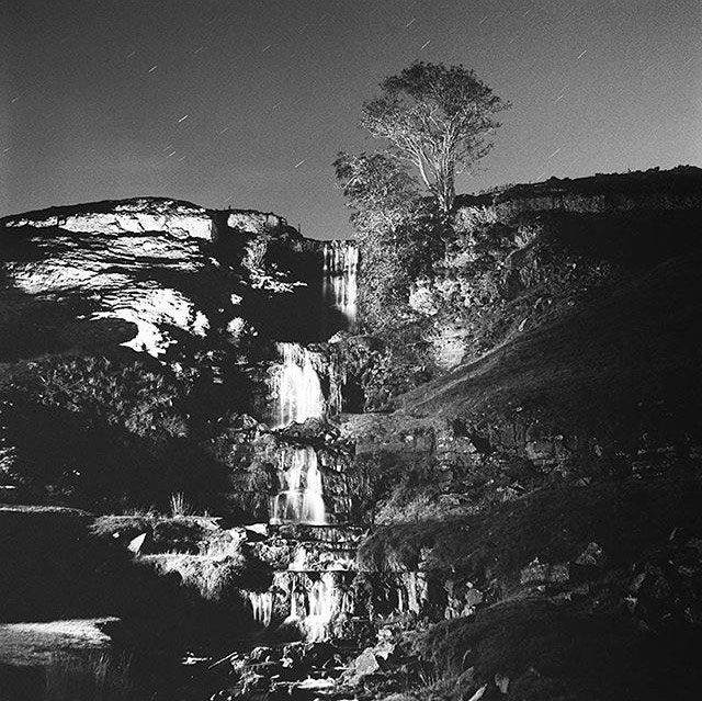 Nighttime - a black and white photograph of waterfall by John Arnison.